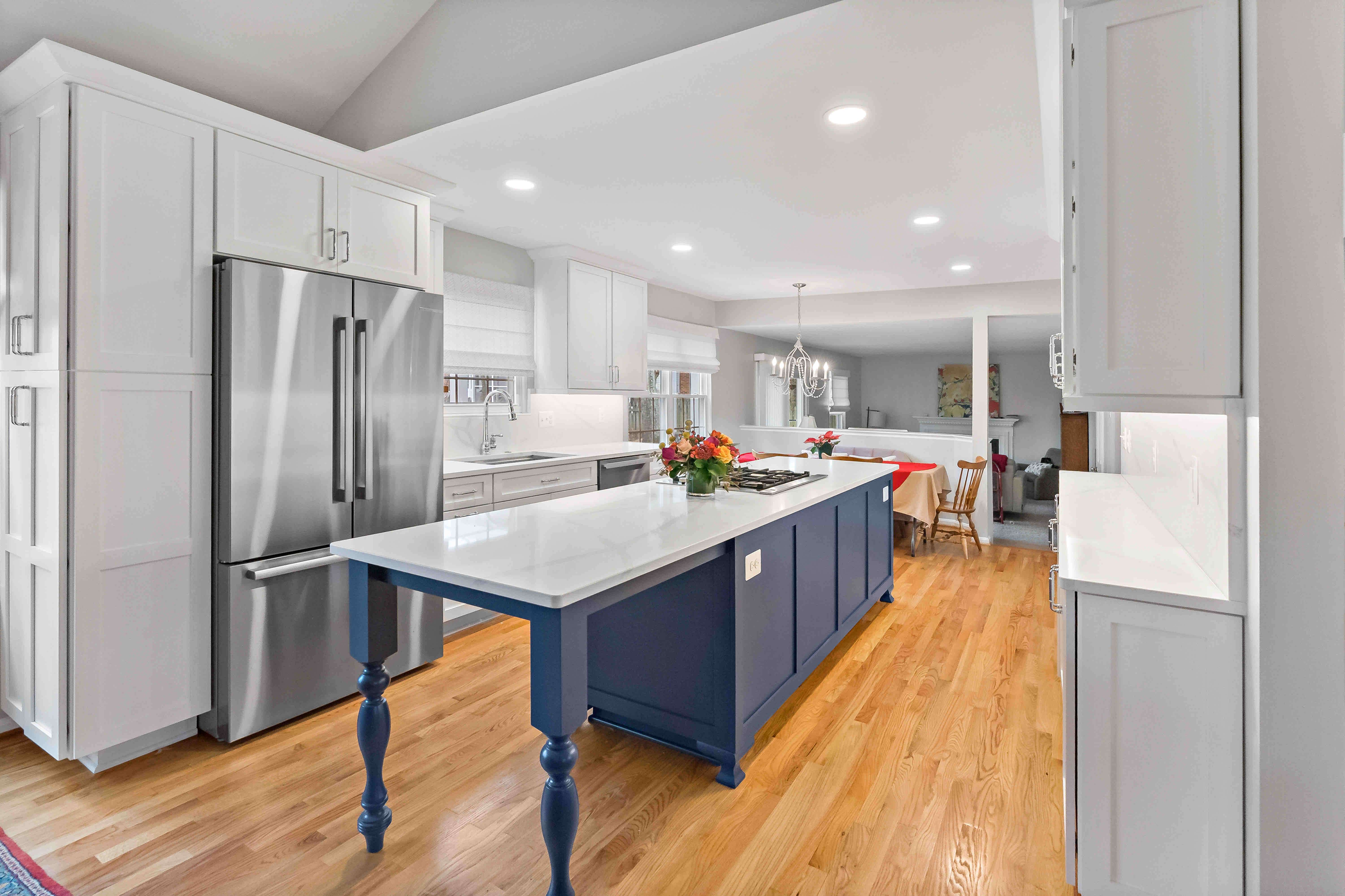 Long rectangular blue kitchen island with white countertop