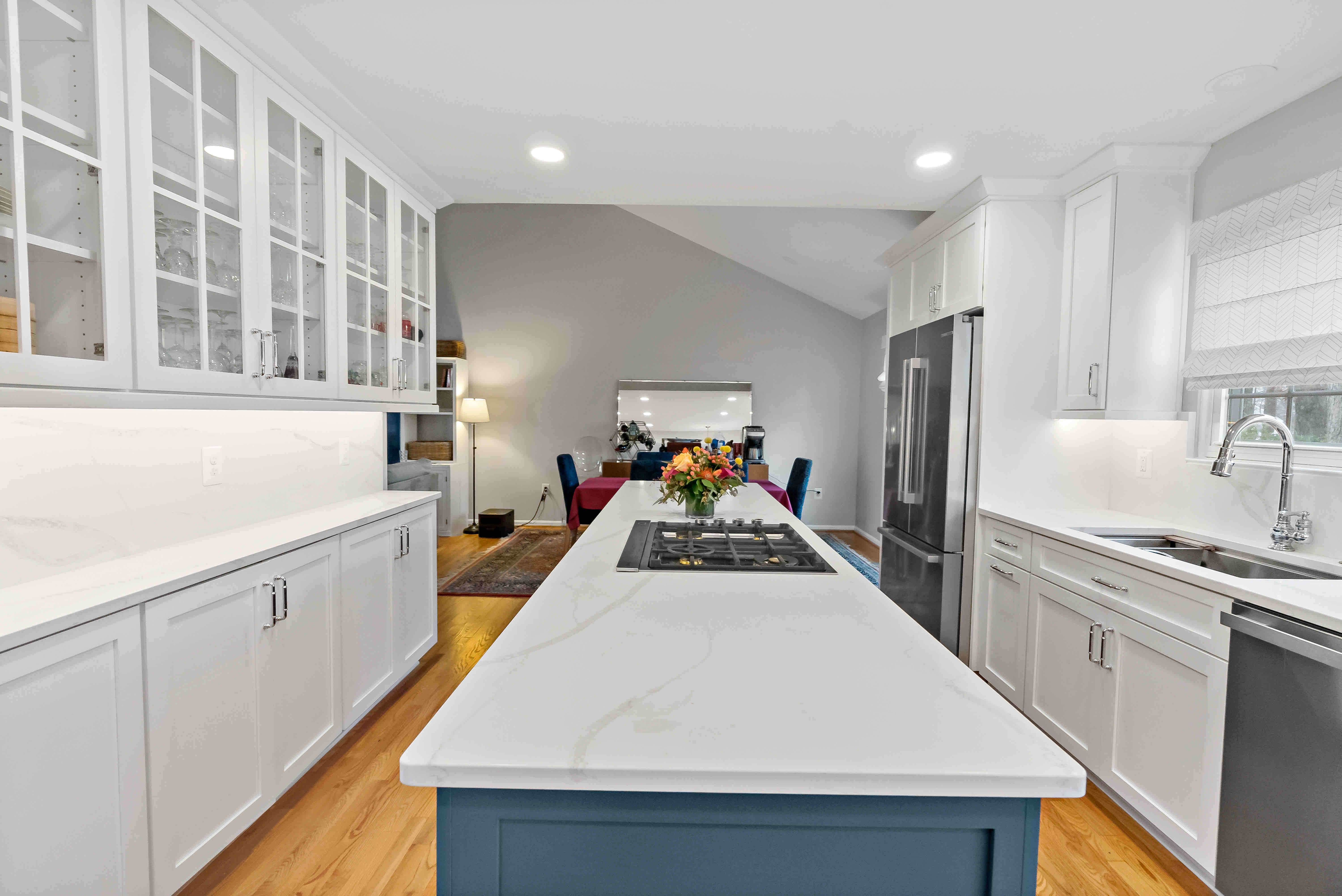 Long kitchen area with white cabinets