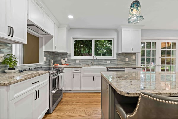 White cabinetry with creamy brown countertops in kitchen