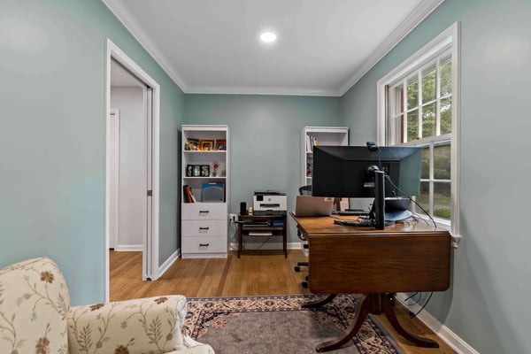 Home office with blue walls and pocket doors