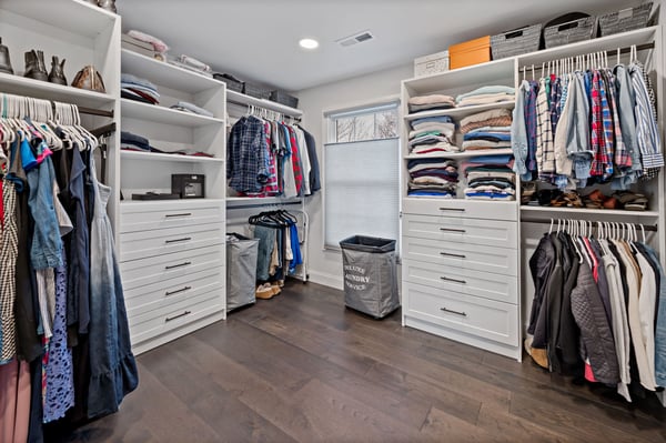 Large, organized walk-in closet with built-ins