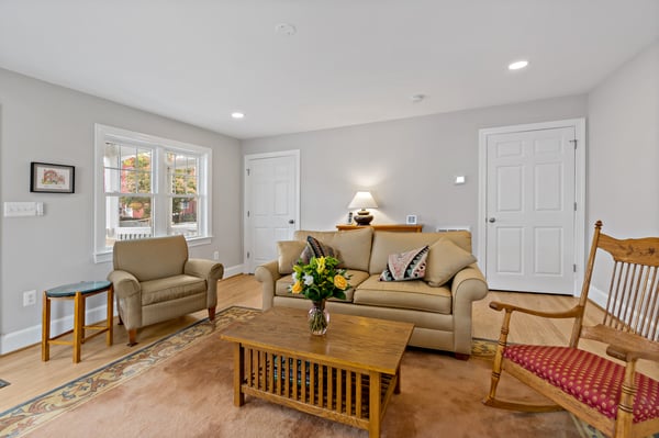 Living room with white walls and beige and wood furniture