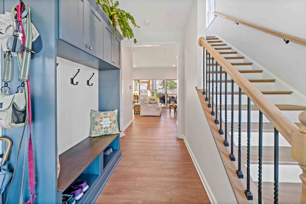 Staircase next to blue mudroom