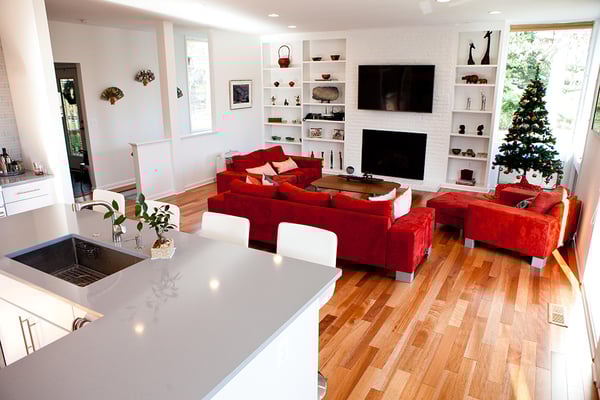 Living room with red couches and a Christmas tree in the corner