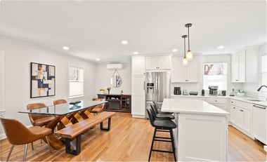 Open concept Arlington kitchen and dining area remodel with white cabinetry, large island, and hardwood floors designed for family gatherings and entertaining.