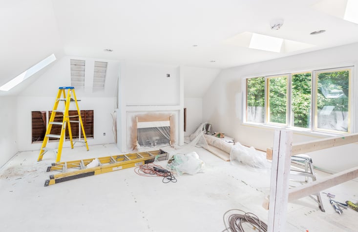 Living room covered in plastic, undergoing a home remodeling project
