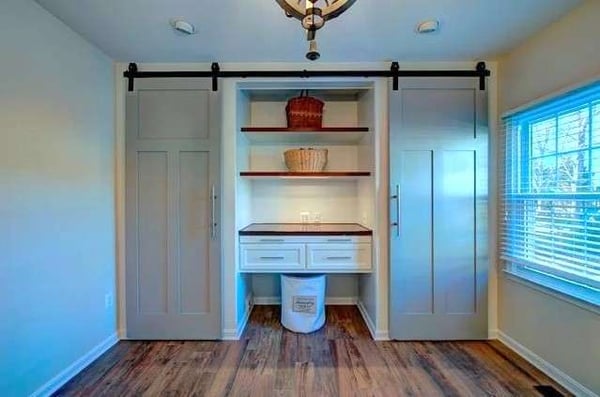 Two grey sliding barn doors in Herndon mudroom