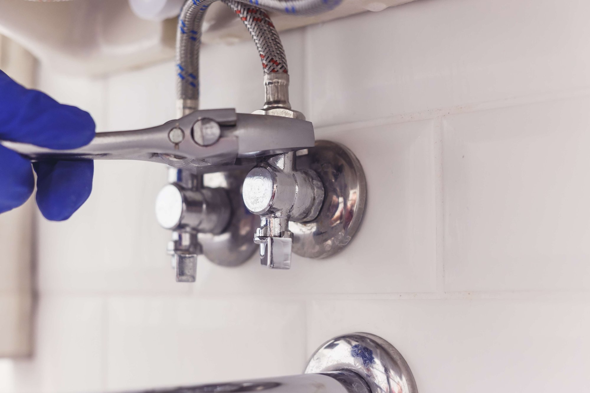 plumber-turns-nut-on-angle-valve-under-wash-basin-2022-12-16-21-51-07-utc plumber-turns-nut-on-angle-valve-under-wash-basin-2022-12-16-21-51-07-utc