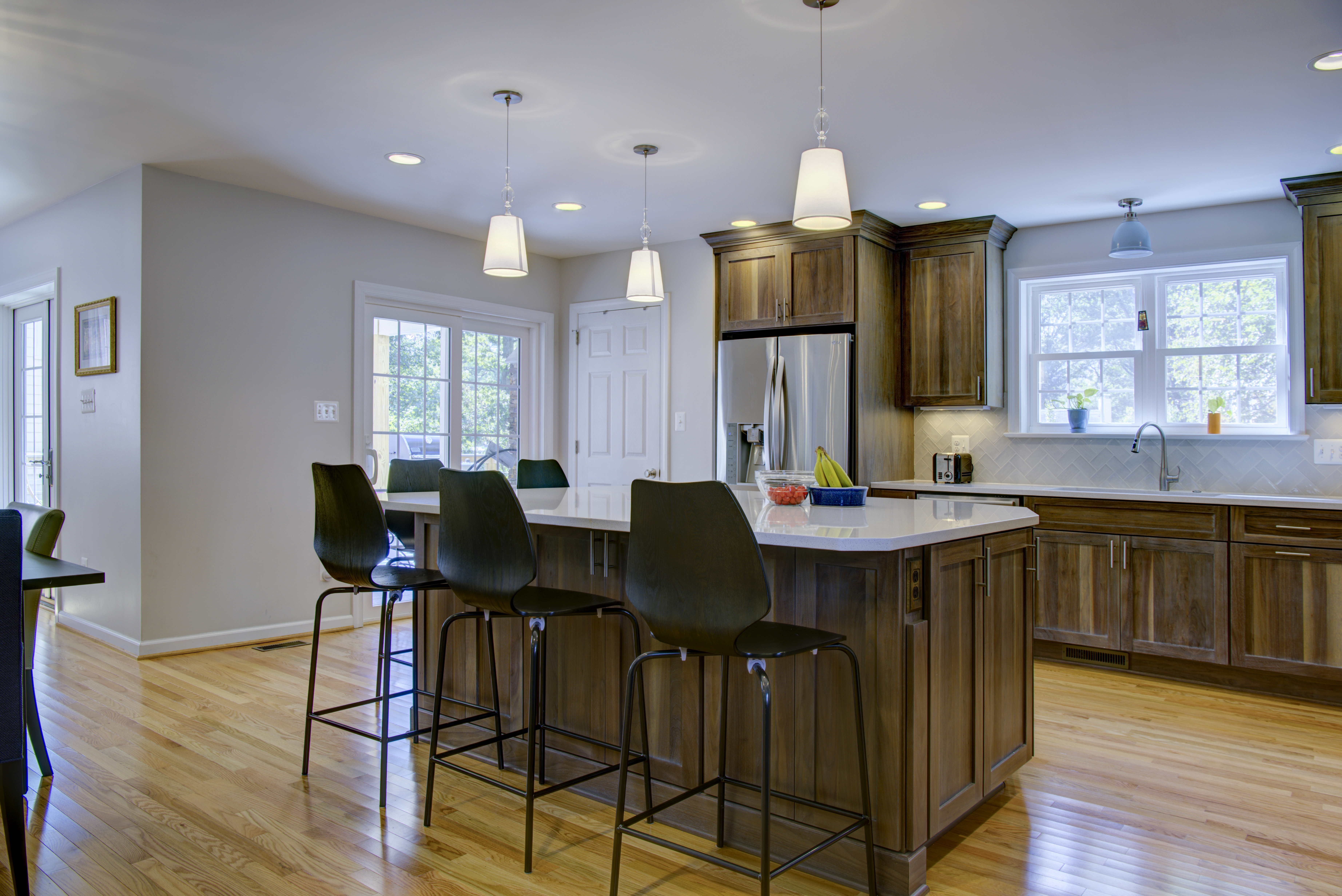 Modern kitchen remodel with dark brown cabinetry and kitchen island