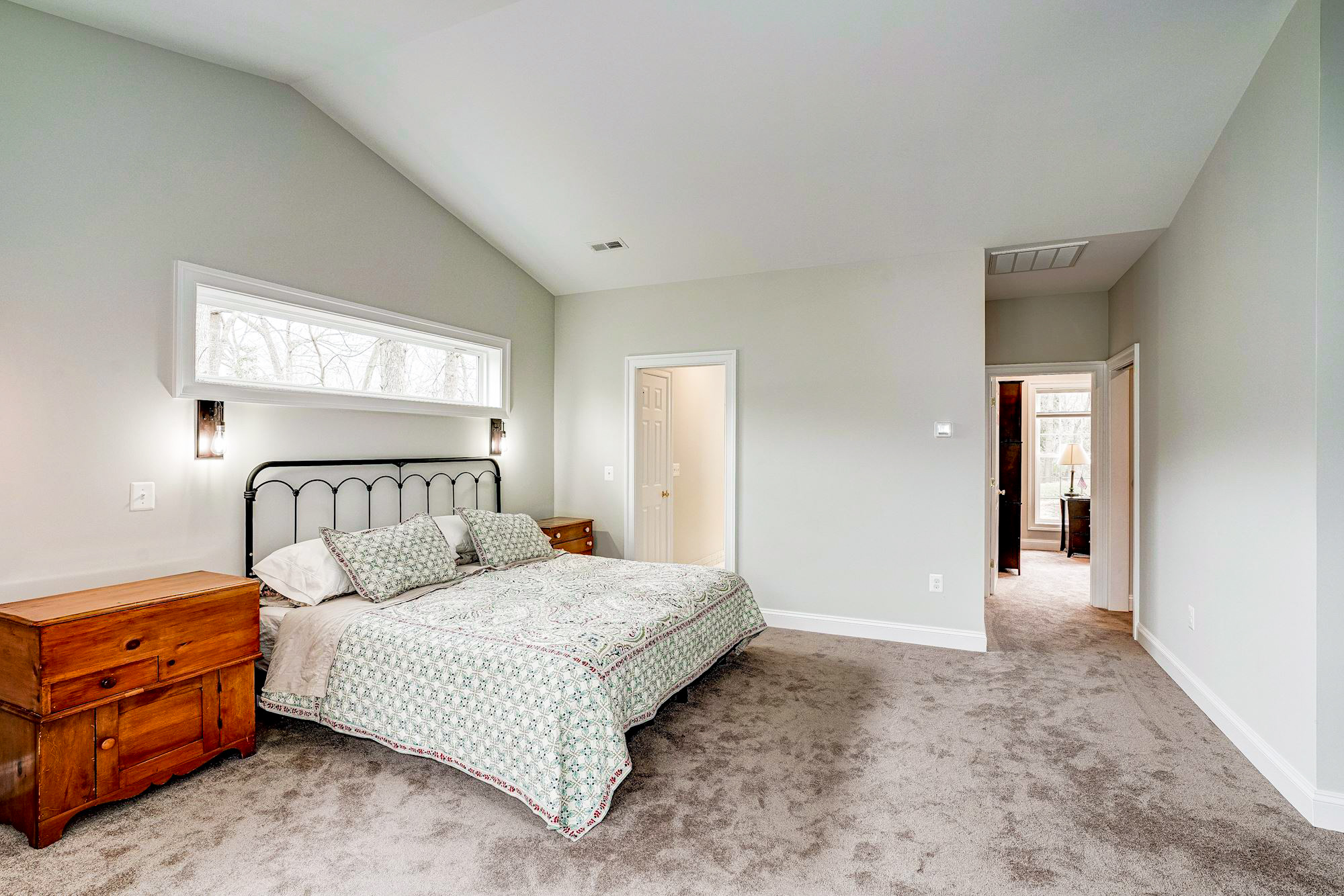 Carpeted bedroom with cathedral ceiling