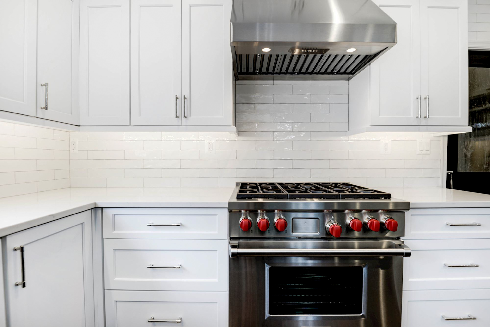 White cabinets with black gas stove and oven
