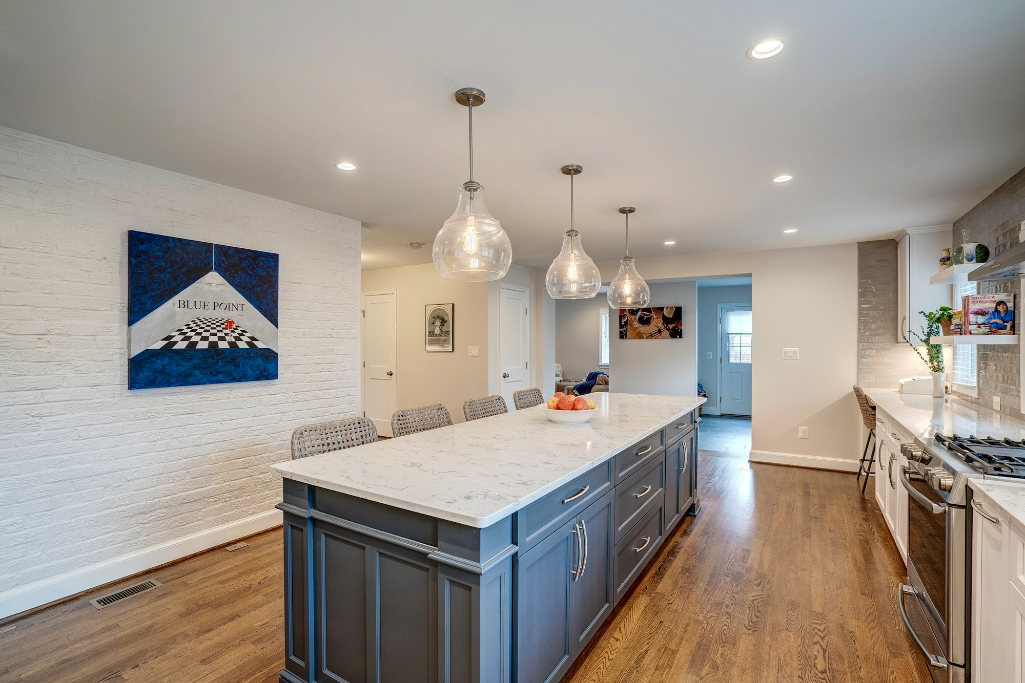 Long skinny kitchen island with pendant lighting above