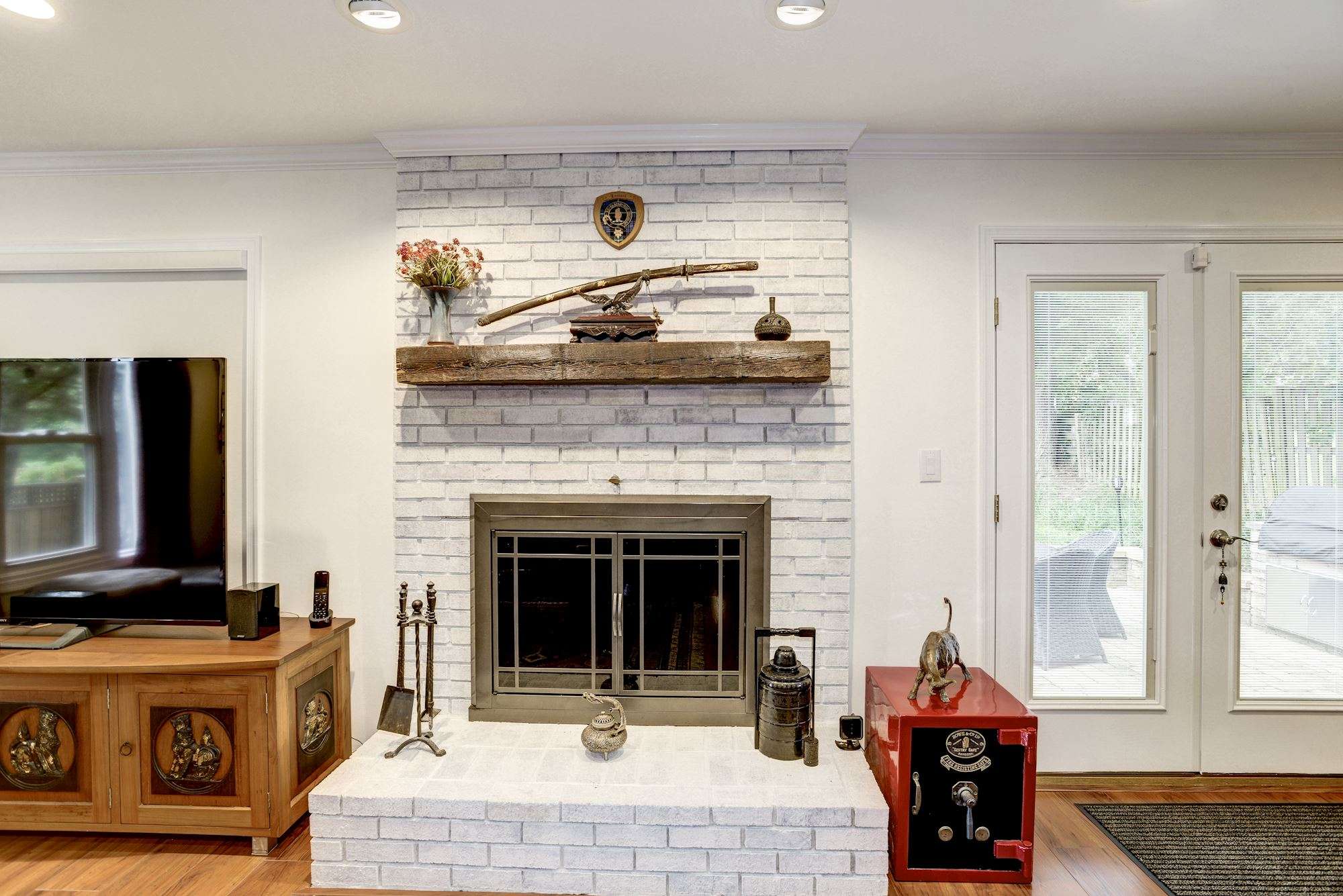 White brick fireplace with wooden mantle