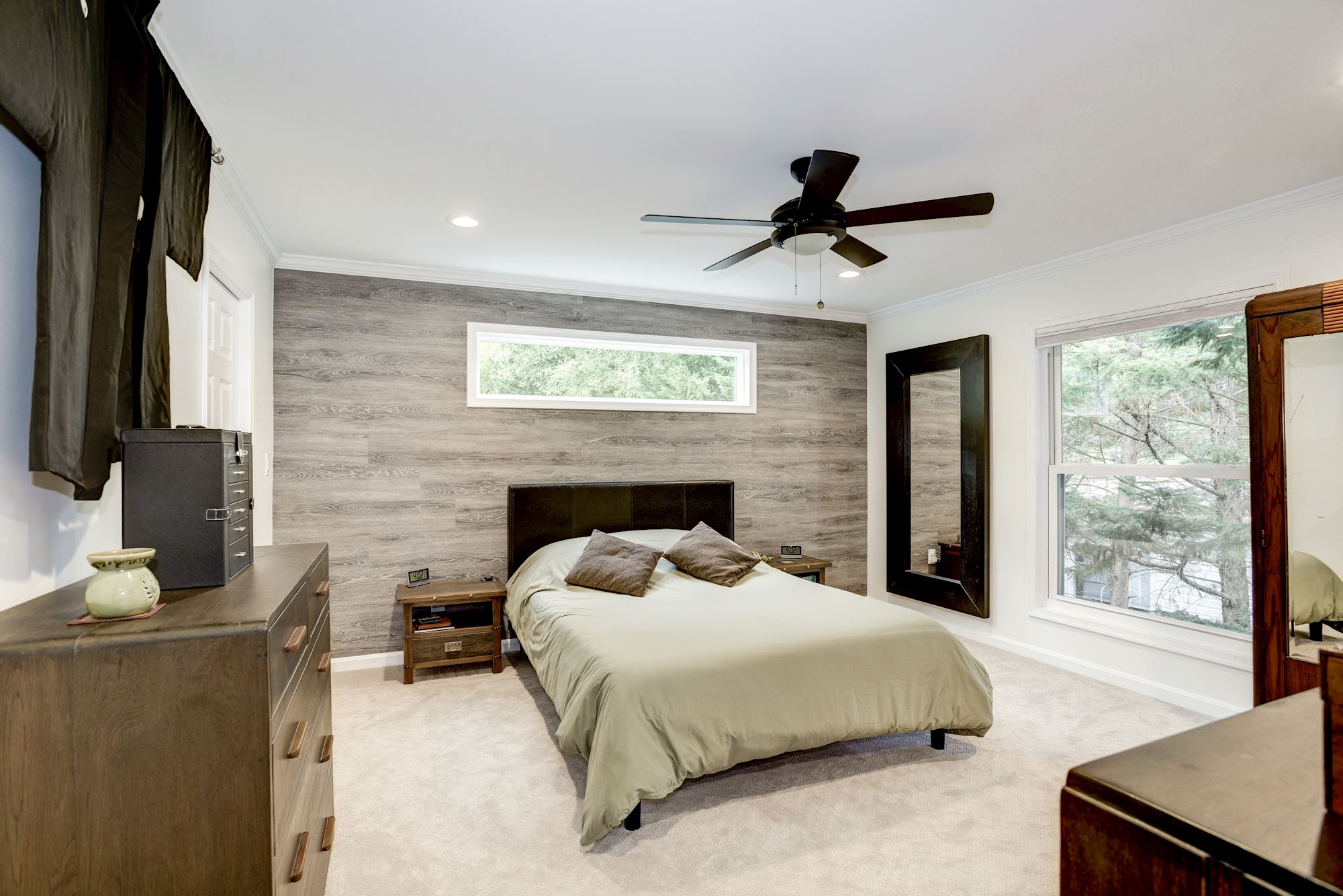 Modern carpeted bedroom with grey wood wall 