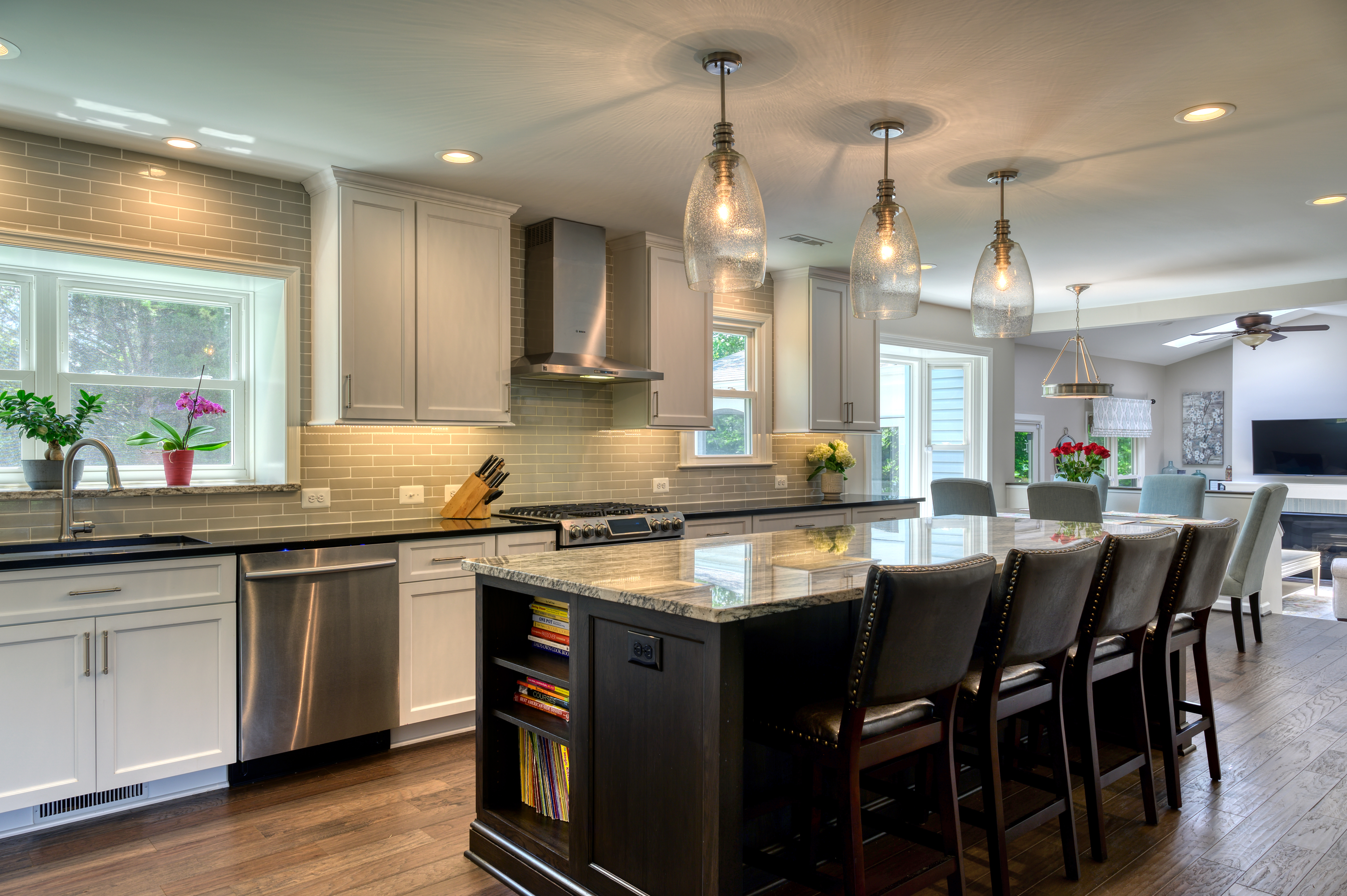 Black kitchen island with granite countertop