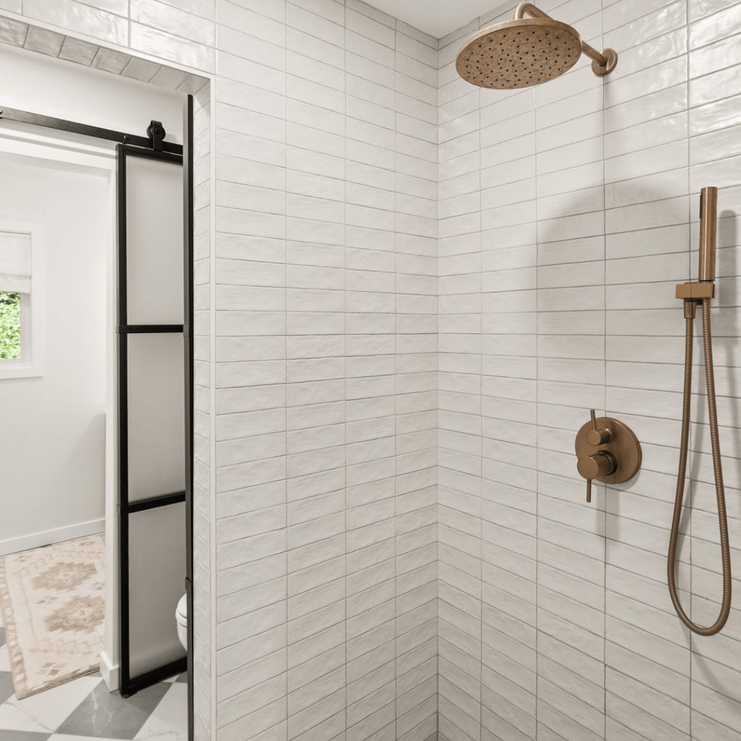 After: spa-inspired bathroom with gold fixtures and sliding barn doors to separate each space