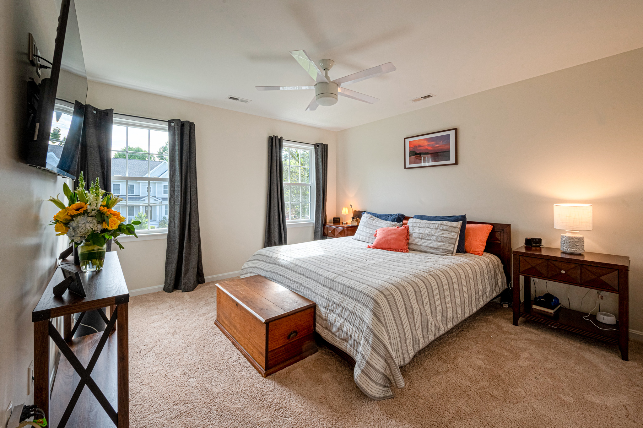 Ceiling fan in beige carpeted bedroom