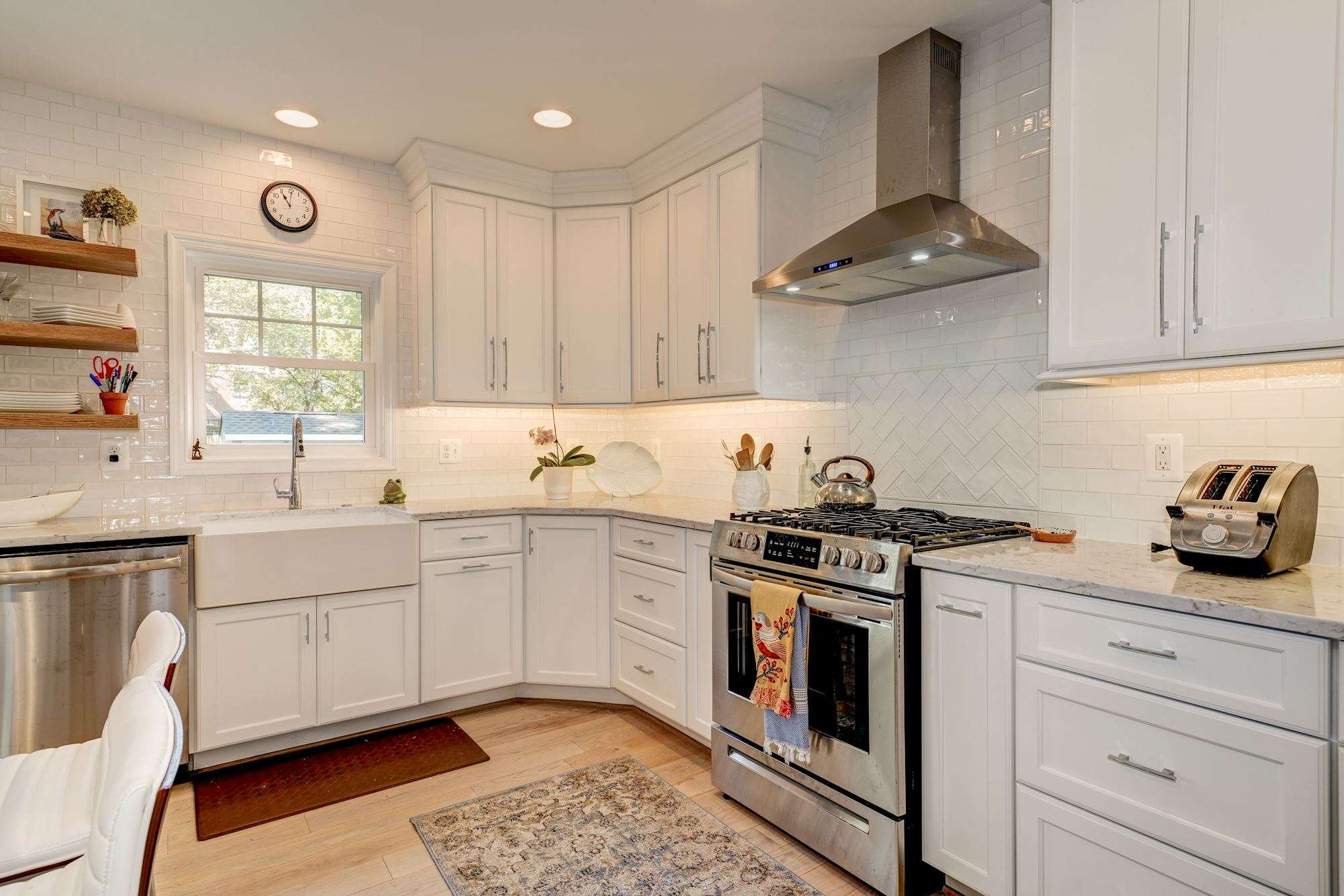 White cabinets in kitchen with floating shelves