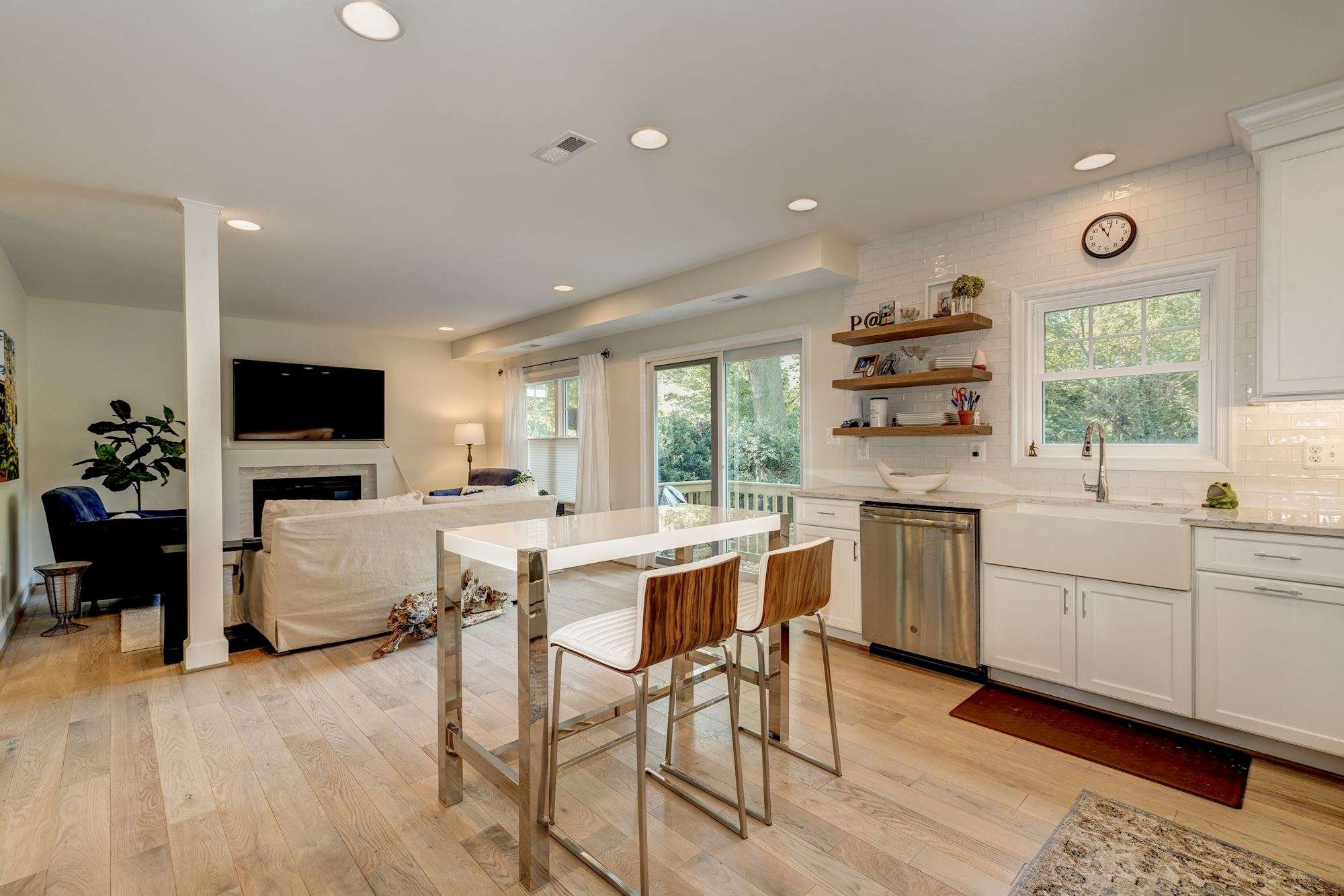 White and silver kitchen with light hard wood floors