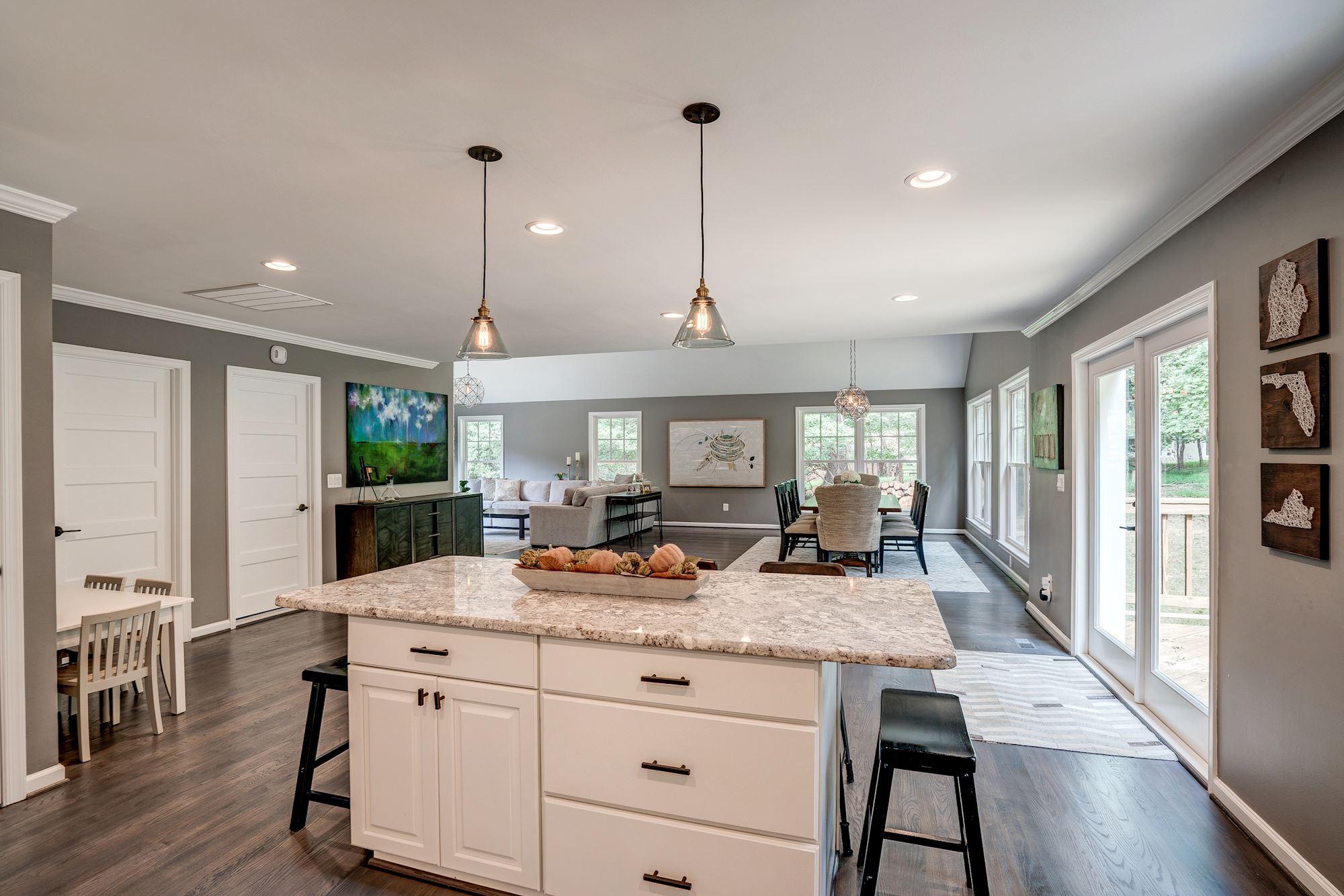 White kitchen island with granite countertop and black fixtures