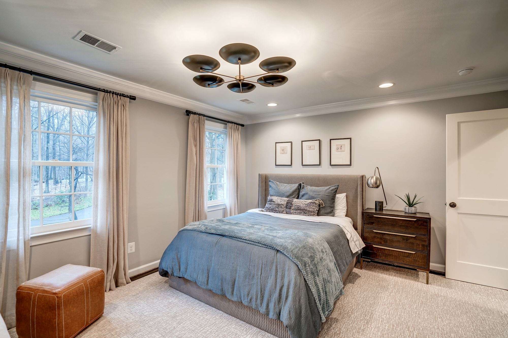 Bedroom with unique ceiling lighting and window treatment