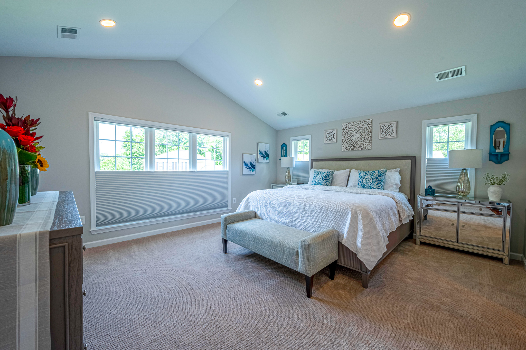 White spacious bedroom with cathedral ceiling