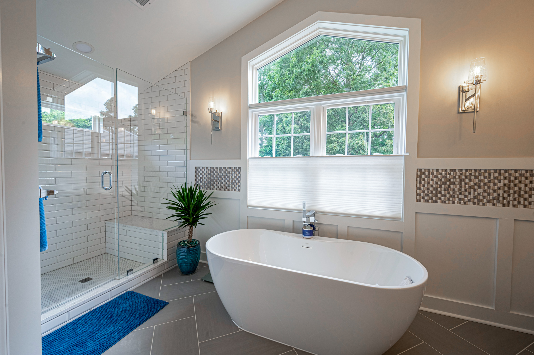 Cathedral ceiling in full master bathroom and glass wall shower