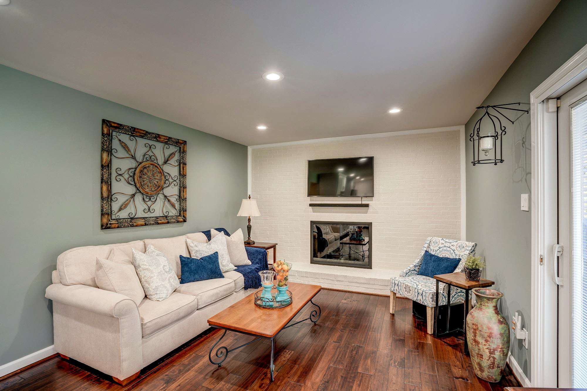 Living room with green walls and hard wood floors