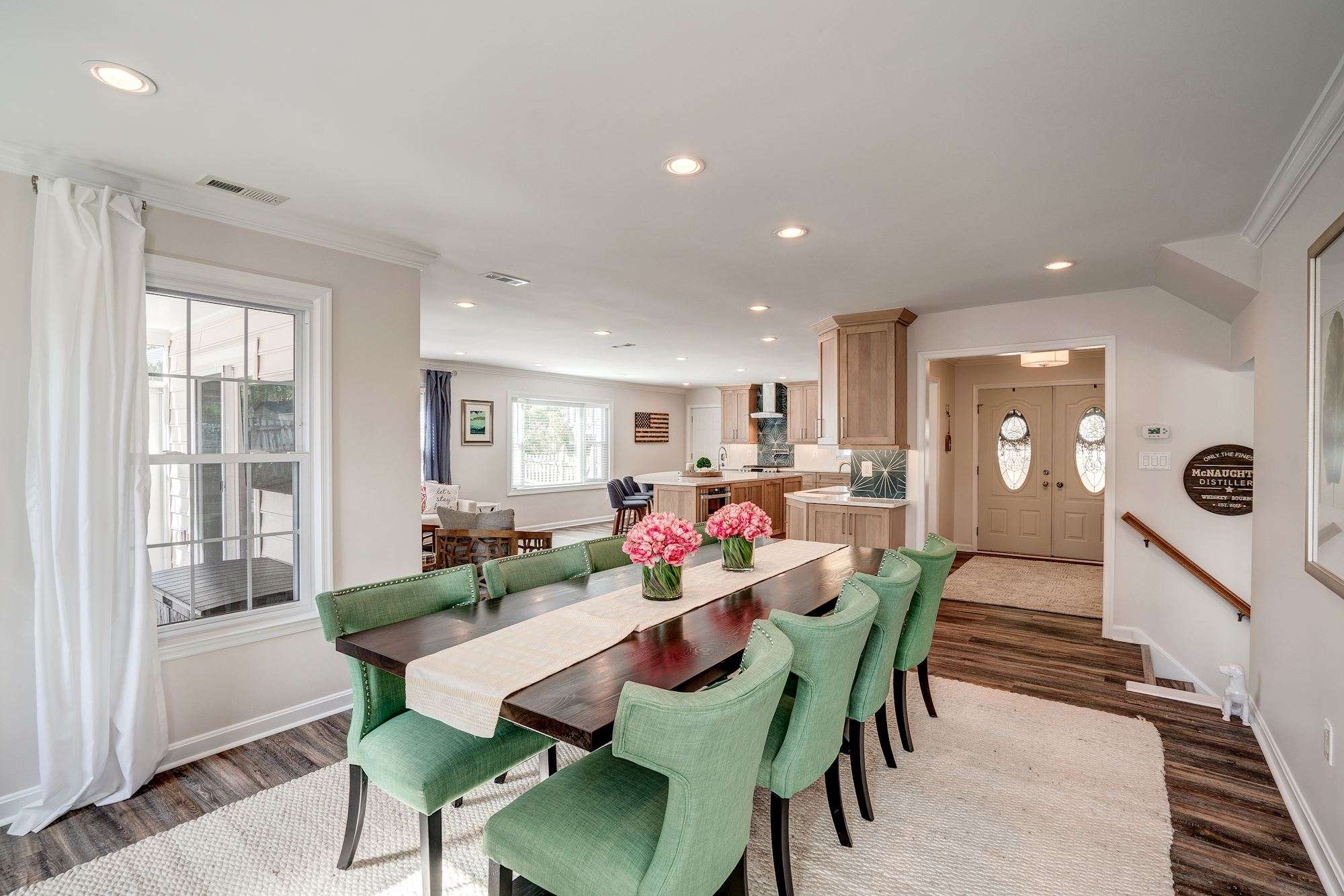 Wood dining room table with green chairs