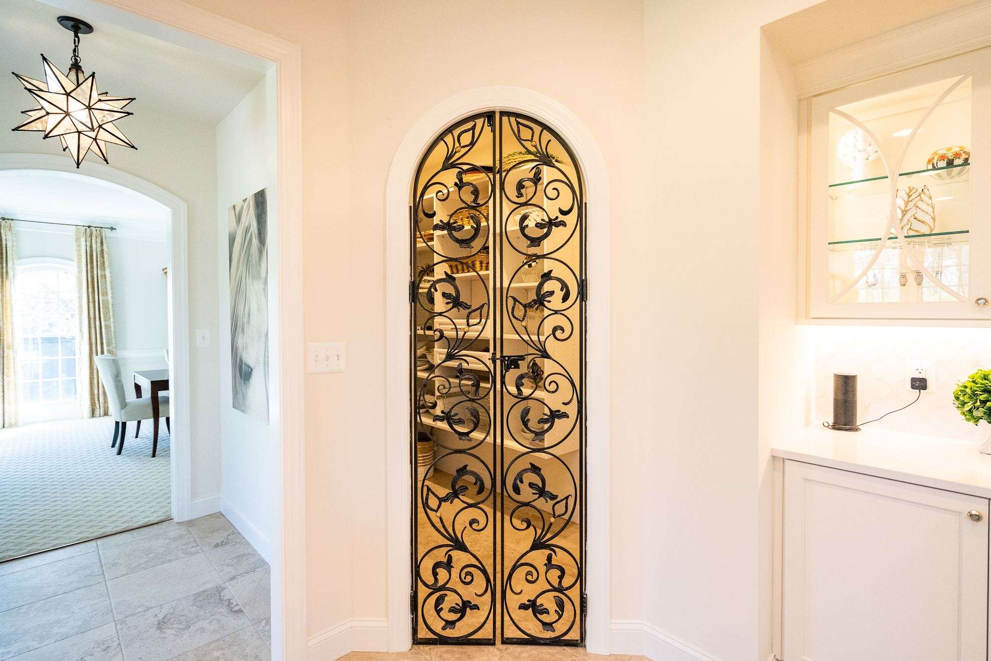 Metal gate see-through pantry door in kitchen