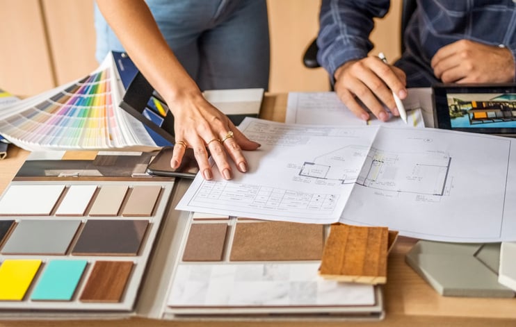 Client and architect reviewing materials and blue prints during home remodel design phase